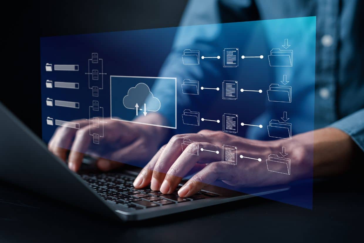 Close-up of hands typing on a laptop keyboard with a digital overlay of cloud computing and file management icons, representing cloud storage, data synchronization, and digital workflow automation."

Let me know if you need any modifications!